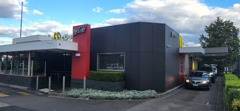 Repainted McCafe restaurant exterior in red and charcoal