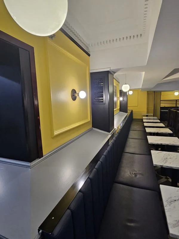Hospitality venue interior with yellow feature walls